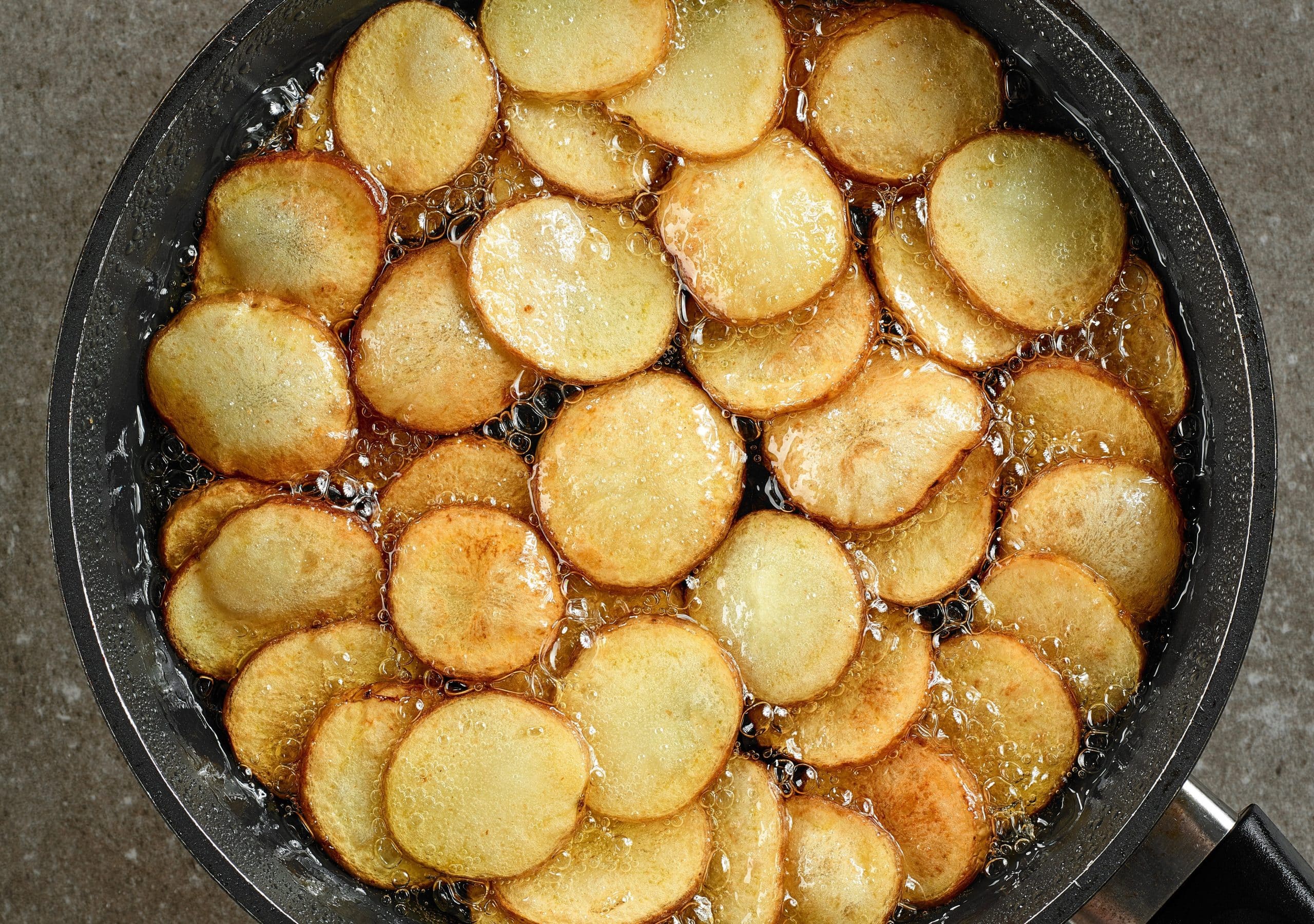 frying potatoes in pan with oil frying potatoes in pan with oil.