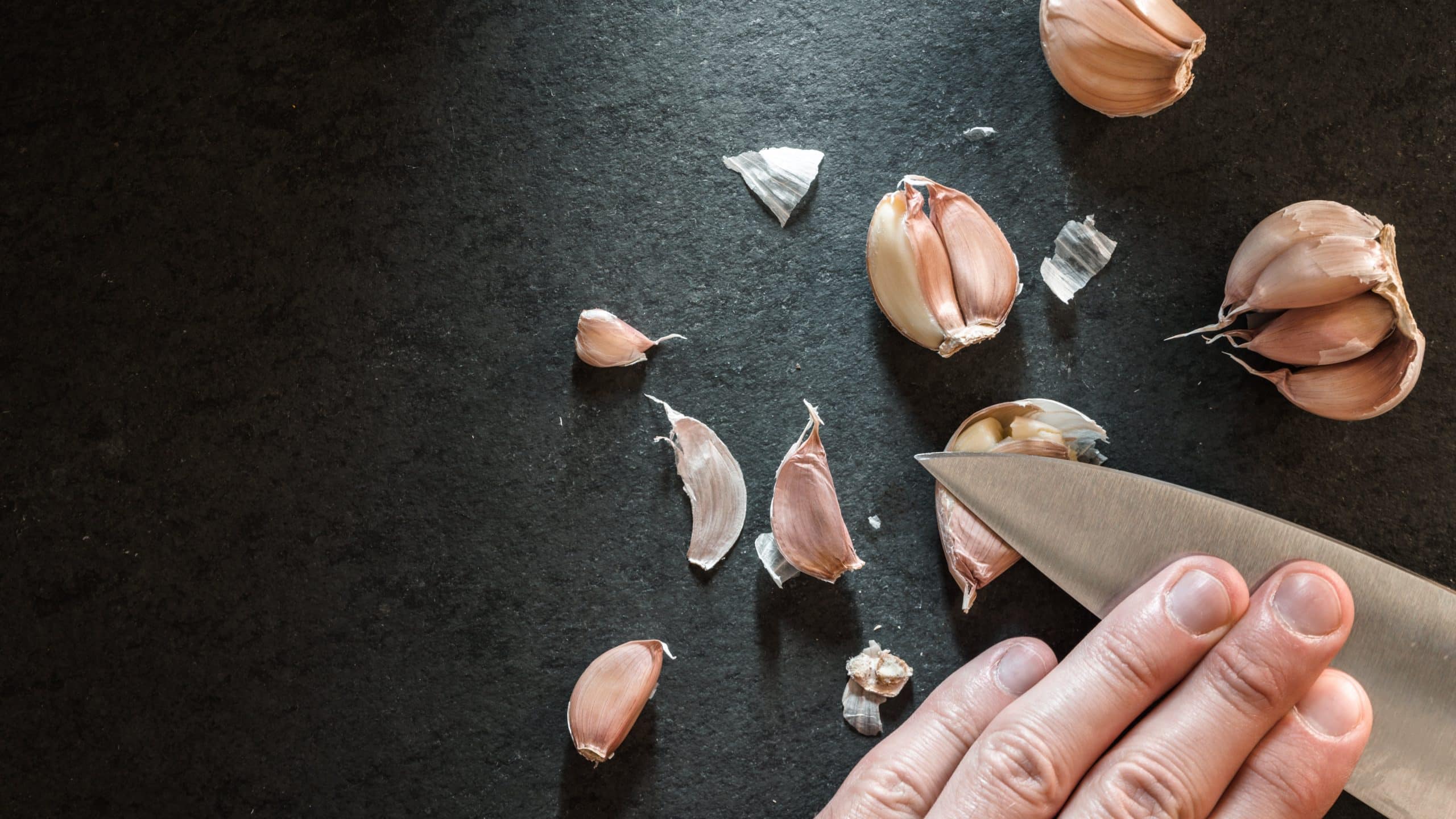 Peeling the garlic with a knife Peeling the garlic with a knife.