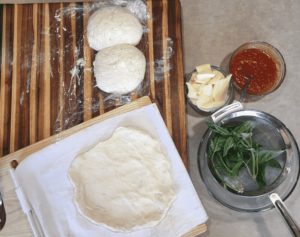 Assembling a Margherita pizza.