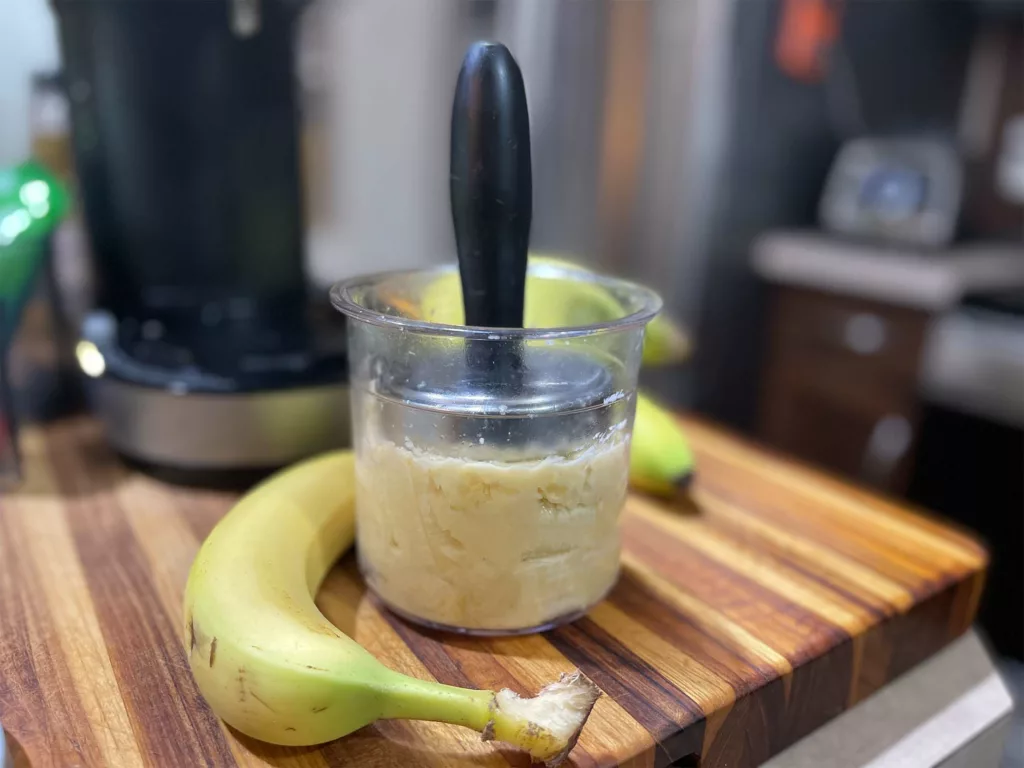 Tamping bananas down before freezing for the Ninja CREAMi ice cream maker.