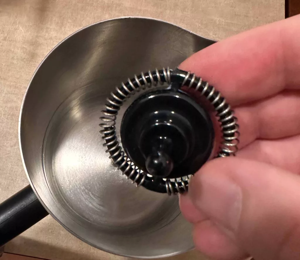 Integrated whisk inside milk frother of the Ninja Luxe Cafe.